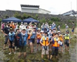 ライフジャケットを着せてもらってたも網を手にした集合写真