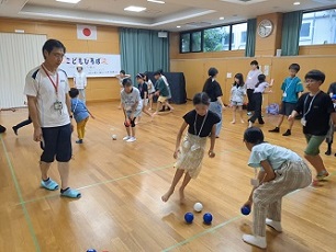 充分な個数を用意したボッチャの球を投げて、思い思いに練習する子ども達のようす