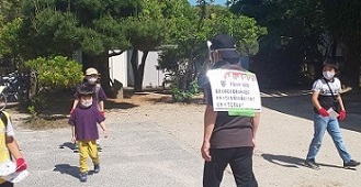 鬼の背中のクイズを見ようとする子どもたちの写真