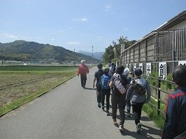 春の景色の中を歩く子どもたちの写真