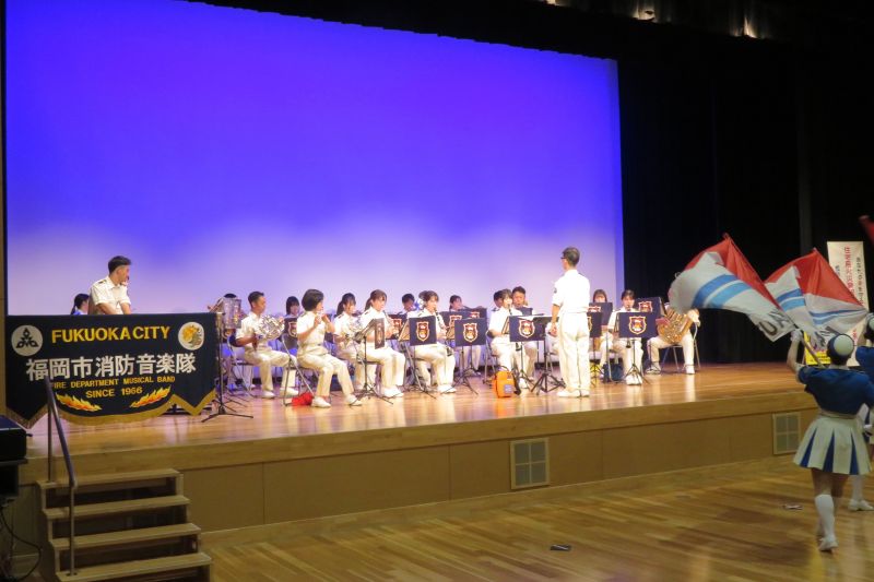 ステージ上で演奏する福岡市消防音楽隊の写真